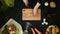 Top view handle shot of young woman cutting fresh vegetables on wooden board