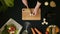 Top view handle shot of young woman cutting fresh vegetables on wooden board