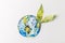top view of handmade colorful paper globe with green leaves isolated on grey, environment protection and recycling concept