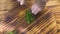 Top view hands chef cook cutting green parsley on wooden board. Chef cook chopping fresh parsley on cutting board