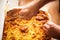 Top view of hands cutting slices of a large finnish pancake