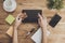 Top view of hands holding tablet table background