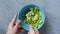 Top view of hands making avocado sauce guacamole