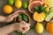 Top view hands pounding mint with pestle in mortar, citrus on dish