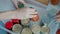 Top view of hands putting canned food and juice bottles in container for donation in charity fund