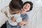 Top view, Happiness Asian mother laying on a bed and playing with her son. Mother\\\'s day