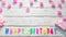 Top view of happy birthday 8 candle letters for a girl in pink shades with beautiful rose flowers, postcard congratulation copy