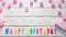 Top view of happy birthday 9 candle letters for a girl in pink shades with beautiful rose flowers, postcard congratulation copy