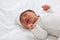 Top view happy newborn baby lying sleeps on a white blanket comfortable and safety.Cute Asian newborn sleeping and napping on bed.