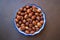 Top view of hazelnuts in porcelain bowl - Image