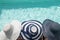 Top view of head of three women wearing straw posing on the edge of the pool