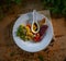 Top view of the healthy appetizing vegan salad on a white plate