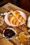 Top view of healthy breakfast with two croissants and honey marmalade and milk on wooden table