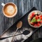 top view of healthy fruity dessert, spoon and cup of coffee