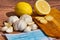 Top view of healthy natural treatments for cold and flu. Lemon slices with ginger and garlic