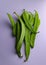 Top view of a heap of flat green beans isolated in the light background