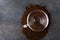 Top view of heap ground coffee,glass cup on dark table.Morning coffee