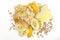 Top view of heap of oatmeal, corn flakes, cereal, pieces of banana, plum, apple, peach on the white background