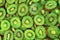 Top view of heap of sliced kiwi as textured background