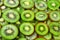 Top view of heap of sliced kiwi as textured background