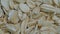 Top view: heap of uncooked oat flakes, oatmeal on rotating surface - close up