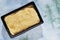 Top view of a heap of uncooked polenta in a blue bowl