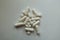 Top view of heap of white magnesium citrate capsules and vitamin K tablets