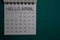 Top view Hello April text on a Calendar isolated on office desk