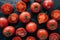 Top view of highly detailed red tomatoes on black background being wet. Juicy appetising vegetables for you to eat. Vagan food