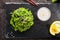 Top View of hiyashi wakame chuka or kelp salad on natural black slate plate background. Seaweed food salat with sesame and nut sau