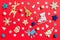 Top view of holiday toys and decorations on red Christmas background. New Year time concept