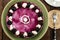 Top view of homemade blackberry cheesecake garnished with preserved blackberry and white cream