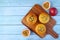 Top View of Homemade Passion Fruit Muffins on Breadboard with Fresh Fruits Scattered on Wooden Background