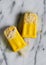 Top view of homemade two popsicles are made from coconut milk and frozen mango