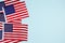 Top view on horisontal composition with american flags on light blue background with copyspace. National symbol of USA - flag Old