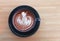 Top view of hot cocoa with foam froth art in black ceramic cup
