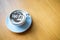 Top view of hot coffee cappuccino cup with milk foam on wood table background. Drinken latte art coffee on wooden table.