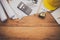 Top view House blueprint and work equipment consisting of a calculator, compass, compass, helmet, placed on a wooden floor.