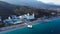 Top view of houses on the palm beach, pool and boat near a wooden pier. Video. Top view of luxury resort on the beach