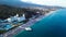 Top view of houses on the palm beach, pool and boat near a wooden pier. Video. Top view of luxury resort on the beach