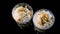 Top view human hand put two white banana mousse dessert in round plastic glass
