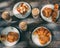 Top view of iced coffee, brioche, croissants, and cake on a wooden table