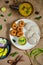 Top view of Idli, Wada, Sambar and Chutney. Traditional South Indian food, surrounded with lemon, raw mango and green chillies.