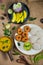 Top view of Idli, Wada, Sambar and Chutney. Traditional South Indian food, surrounded with lemon, raw mango and green chillies