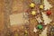 Top view image of christmas festive decorations next to empty note on old wooden background