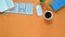 Top view image of colorful workplace. Wireless mouse, keyboard, coffee cup, notebook, pencil and potted plant .