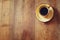 Top view image of cup of black coffee over wooden textured table background. room for text