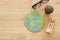 Top view image of desk with glasses , hourglass and earth globe.