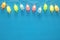 Top view image of ice cream cute party garland lights over wooden blue background.