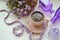 Top view image of little purple flowers next to cup of coffee on white wooden table. vintage.morning breakfast concept in violet